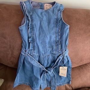 NWT adorable ruffle denim romper with button up back.